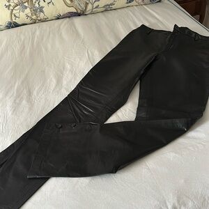 Black leather pants with buttoned slit at the bottom.